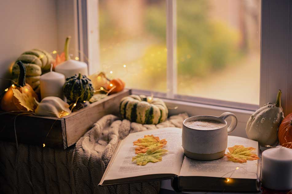 Cozy Fall scene of coffee mug and pumpkins